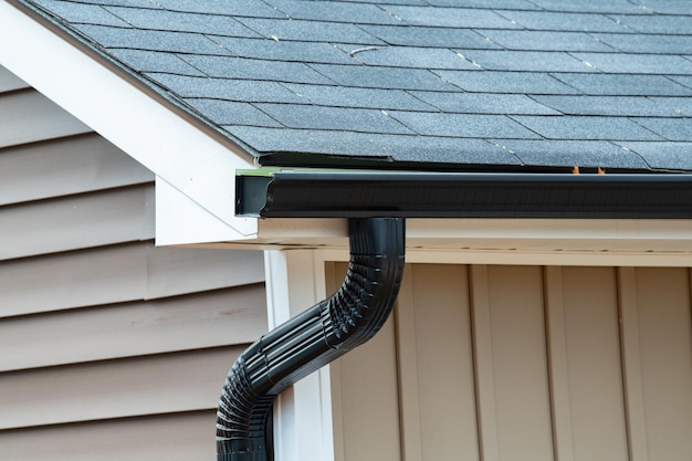 Affordable and professional gutter cleaning in Chelan with technician clearing debris from residential gutters